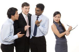 three-businessmen-talk-about-a-female-colleague-behind-her-back